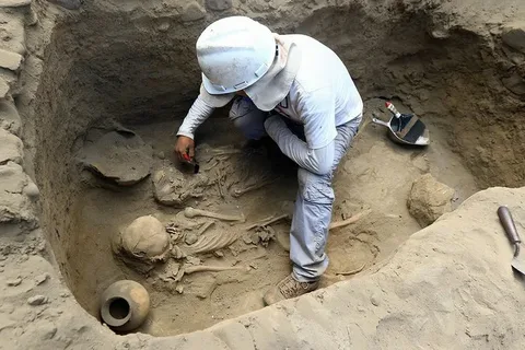 Archaeologists conducting an excavation at a historical site, uncovering artifacts and features